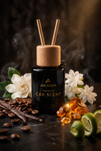 A black glass bottle of Akasia Premium Car Scent with a natural wood reed diffuser top and two reeds, styled on a dark surface with coffee beans, vanilla beans, white flowers, amber crystals, and lime slices.